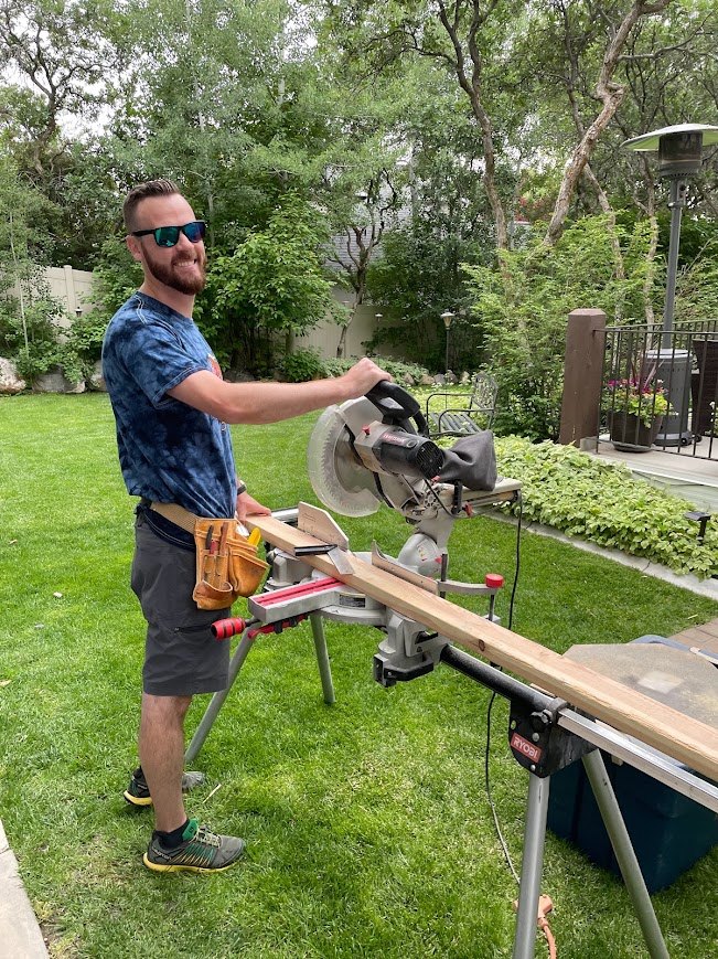 Kyle cutting trim on a miter saw